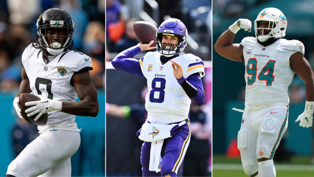 Calvin Ridley runs with the ball; Kirk Cousins throws; Christian Wilkins flexes one arm